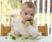 Baby self feeding broccoli